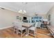 Open-concept living room with hardwood floors, modern lighting and water view at 95 N Marion Ct # 226, Punta Gorda, FL 33950