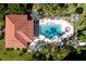 Aerial view of a luxurious community pool with lounge chairs and lush landscaping at 95 N Marion Ct # 226, Punta Gorda, FL 33950