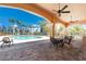 Resort-style pool and lounging area with multiple tables and seating under a covered patio with ceiling fans at 95 N Marion Ct # 226, Punta Gorda, FL 33950