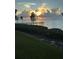Waterfront view with a pier, lush greenery, and a beautiful sunset at 95 N Marion Ct # 226, Punta Gorda, FL 33950