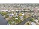 Aerial view of a waterfront property with dock and lush surroundings, close to commercial area at 103 Curtis Ne Ter, Port Charlotte, FL 33952