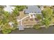 Canal-front home showcasing a private dock, garden, and meticulously maintained grounds at 103 Curtis Ne Ter, Port Charlotte, FL 33952