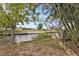 Tranquil backyard with lush greenery and canal view, offering serene outdoor living with direct water access at 103 Curtis Ne Ter, Port Charlotte, FL 33952