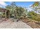 Backyard with lush landscaping, a charming water feature, and access to a patio and outdoor storage at 103 Curtis Ne Ter, Port Charlotte, FL 33952
