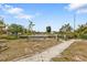 Expansive backyard leading to a waterway with a private dock, offering serene waterfront living at 103 Curtis Ne Ter, Port Charlotte, FL 33952