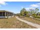 Spacious backyard with a pathway, leading to serene water views and lush greenery, ideal for outdoor relaxation at 103 Curtis Ne Ter, Port Charlotte, FL 33952