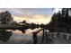 Scenic canal-front backyard view highlighting water access, lush landscaping, and a serene sunset setting at 103 Curtis Ne Ter, Port Charlotte, FL 33952