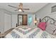 Bedroom featuring wood-look floors, ceiling fan, with view to ensuite bathroom at 103 Curtis Ne Ter, Port Charlotte, FL 33952