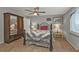Comfortable bedroom featuring wood-look floors, ceiling fan, and wardrobe at 103 Curtis Ne Ter, Port Charlotte, FL 33952