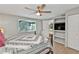 Bedroom featuring wood-look floors and built-in shelving with a view to a side patio at 103 Curtis Ne Ter, Port Charlotte, FL 33952