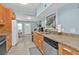 Bright and modern kitchen featuring stainless steel appliances and tile flooring at 103 Curtis Ne Ter, Port Charlotte, FL 33952