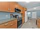 Kitchen with stainless steel appliances, granite countertops, and tile flooring at 103 Curtis Ne Ter, Port Charlotte, FL 33952