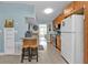 Functional kitchen with light wood cabinetry, a breakfast bar, and essential appliances at 103 Curtis Ne Ter, Port Charlotte, FL 33952