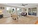Inviting living room with light-colored walls, wood-look floors, and a sliding door for outdoor access at 103 Curtis Ne Ter, Port Charlotte, FL 33952