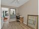 Home office featuring wood-look flooring and desk area with a view to the patio at 103 Curtis Ne Ter, Port Charlotte, FL 33952