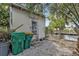 Outdoor shed next to trash bins, offering practical storage solutions with waterfront views at 103 Curtis Ne Ter, Port Charlotte, FL 33952