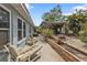 Outdoor patio featuring seating areas and a landscaped backyard for relaxing and entertaining at 103 Curtis Ne Ter, Port Charlotte, FL 33952