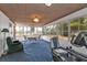 Sunroom with large windows, blue carpet and exercise equipment at 103 Curtis Ne Ter, Port Charlotte, FL 33952