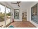 Cozy sunroom with brick flooring and large windows with views of the outdoor space at 103 Curtis Ne Ter, Port Charlotte, FL 33952