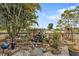Landscaped yard featuring a charming rock waterfall and lush tropical plants adding a touch of nature at 103 Curtis Ne Ter, Port Charlotte, FL 33952