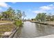 Scenic waterfront view showcasing canal, docks, and lush landscaping, promising a tranquil and picturesque setting at 103 Curtis Ne Ter, Port Charlotte, FL 33952