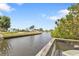 Tranquil canal with lush landscaping, showcasing serene waterfront living at 103 Curtis Ne Ter, Port Charlotte, FL 33952