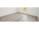 Bright bedroom with wood-look flooring and a large window at 11456 5Th Ave, Punta Gorda, FL 33955