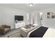 Well-lit bedroom featuring a lounge area, walk-in closet, and ensuite bathroom at 11456 5Th Ave, Punta Gorda, FL 33955