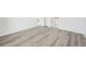 Spacious bedroom with wood-look flooring and an ensuite bathroom at 11456 5Th Ave, Punta Gorda, FL 33955