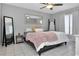 Comfortable bedroom with a large decorative mirror, gray walls and neutral decor, tile floors at 1211 Saxony Cir # B5, Punta Gorda, FL 33983