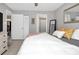 Cozy bedroom with neutral paint and decor, featuring mirror accent and tile floors throughout at 1211 Saxony Cir # B5, Punta Gorda, FL 33983