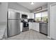 Bright kitchen featuring stainless steel appliances, white cabinets, and a window over the sink at 1211 Saxony Cir # B5, Punta Gorda, FL 33983