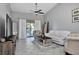 Bright living room featuring a ceiling fan, balcony access and neutral tones at 1211 Saxony Cir # B5, Punta Gorda, FL 33983