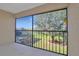 A screened porch features view of the lawn, trees, and neighborhood, for relaxing outdoors at 1211 Saxony Cir # B5, Punta Gorda, FL 33983