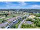 Expansive aerial view of the community featuring golf course, multiple pools, well-maintained landscaping, and residential buildings at 1235 Saxony Cir # 5202, Punta Gorda, FL 33983