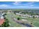 Aerial view showcasing the condo complex nestled along a picturesque golf course and waterway at 1235 Saxony Cir # 5202, Punta Gorda, FL 33983