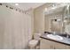 Bathroom featuring a vanity with a sink, a toilet and a shower-tub combo with a seashell patterned shower curtain at 1235 Saxony Cir # 5202, Punta Gorda, FL 33983