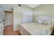 Bedroom features light green walls, light wood floors, closet, and a bed with a light-colored leaf-patterned comforter at 1235 Saxony Cir # 5202, Punta Gorda, FL 33983