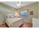 Bright bedroom featuring a decorative ceiling fan, a large window and hardwood floors at 1235 Saxony Cir # 5202, Punta Gorda, FL 33983
