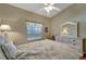Comfortable bedroom with a white dresser, mirror, a leafy comforter and a large window for lots of natural light at 1235 Saxony Cir # 5202, Punta Gorda, FL 33983