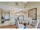 Dining area with chandelier and view into kitchen at 1235 Saxony Cir # 5202, Punta Gorda, FL 33983