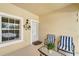 Inviting front porch with seating, decorative wreath, and secure storm door entry at 1235 Saxony Cir # 5202, Punta Gorda, FL 33983