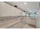 Bright kitchen featuring white cabinets and tile backsplash at 1235 Saxony Cir # 5202, Punta Gorda, FL 33983
