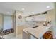 Bright kitchen featuring white cabinets, bar seating, and tile flooring at 1235 Saxony Cir # 5202, Punta Gorda, FL 33983