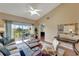 Bright living room features vaulted ceiling, fan, and sliding glass doors to a balcony overlooking a pleasant view at 1235 Saxony Cir # 5202, Punta Gorda, FL 33983