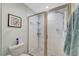 Tiled shower with glass door, hand-held sprayer and storage on corner shelving at 1235 Saxony Cir # 5202, Punta Gorda, FL 33983