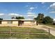 Well-lit single-story home featuring a brick foundation, lush green lawn, and a long driveway at 134 Peace Island Dr, Punta Gorda, FL 33950