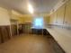 Outdated kitchen needing renovation with tile floor, sink, cabinets, and missing drywall at 134 Peace Island Dr, Punta Gorda, FL 33950
