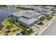 Stunning aerial view of a luxury townhome community on a lake with lush landscaping and paver driveways at 14617 Sycamore Ct # 2211, Punta Gorda, FL 33955