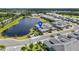 Aerial view of a beautiful townhome in a lush community with a serene lake backdrop at 14617 Sycamore Ct # 2211, Punta Gorda, FL 33955